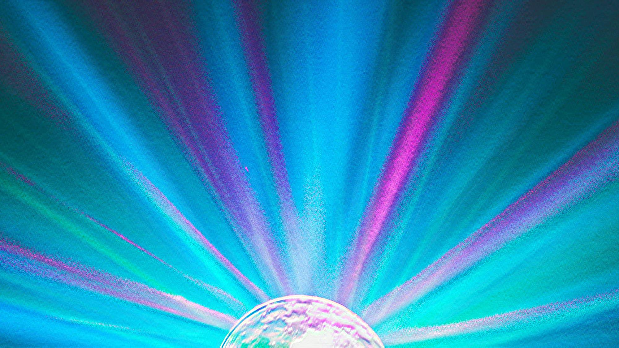 artistic rendering of pink, green and blue light rays spreading out from a round light source
