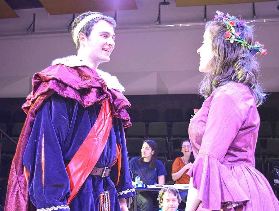 actor dressed as king converses with actor in purple dress