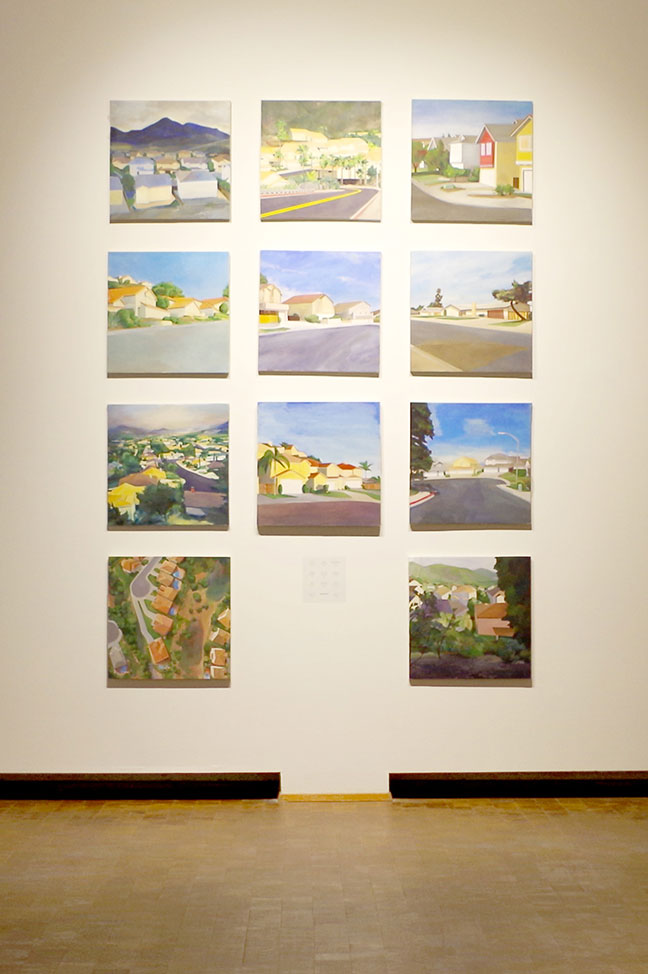 A 3 wide by 4 high grid of square paintings. The middle space in the bottom row in blank wall.