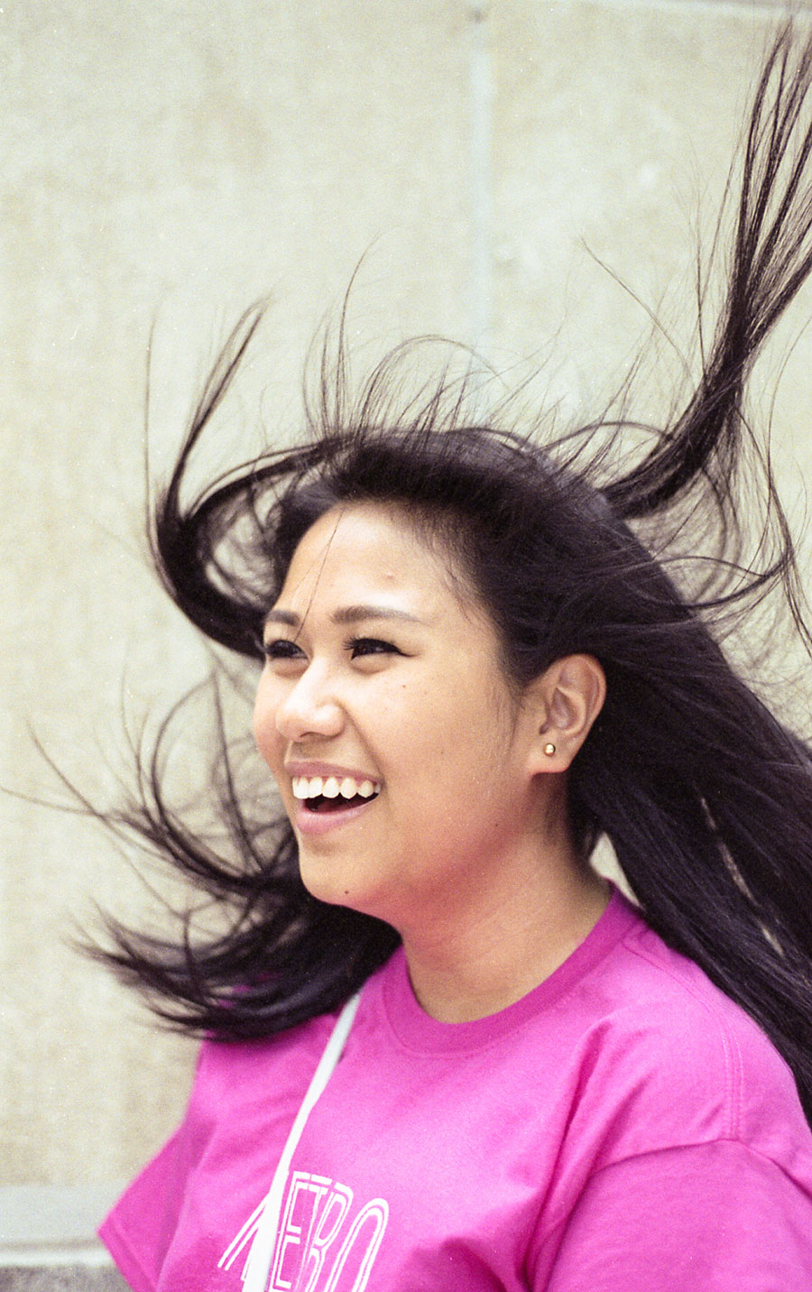 smiling young woman with hair blowing upward