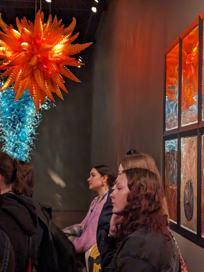 students in a glass art gallery